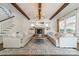 Bright living room boasts wood beams, stone fireplace, and comfortable seating at 4912 Kenbury Ct, Fort Mill, SC 29708