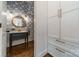 Stylish powder room features custom cabinetry, a marble countertop, and designer wallpaper at 4912 Kenbury Ct, Fort Mill, SC 29708