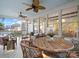 Cozy screened porch features a ceiling fan, wooden table, and wicker furniture perfect for entertaining guests at 4912 Kenbury Ct, Fort Mill, SC 29708