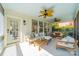 Relaxing screened porch with white painted floors, plush outdoor furniture, and a ceiling fan at 4912 Kenbury Ct, Fort Mill, SC 29708