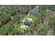 Aerial view of a house with a pond, surrounding forest, and landscaped grounds at 525 Lake Lynn Rd, Concord, NC 28025