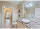 Bathroom featuring a single vanity, wood-look floors, and an ornate framed mirror at 525 Lake Lynn Rd, Concord, NC 28025