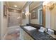 A bathroom with a tiled shower, granite vanity, and framed mirror at 525 Lake Lynn Rd, Concord, NC 28025