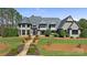 Stunning stone home with lush lawn, elegant landscaping, and a stone walkway at 525 Lake Lynn Rd, Concord, NC 28025