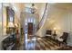 Elegant foyer features stone wall, hardwood floors, curved staircase, and plenty of natural light at 525 Lake Lynn Rd, Concord, NC 28025