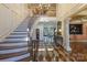 Grand foyer boasts hardwood floors, curved staircase, and elegant chandelier, creating a stunning entrance at 525 Lake Lynn Rd, Concord, NC 28025