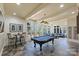 Entertain in style in this bright game room with a pool table and views of the backyard at 525 Lake Lynn Rd, Concord, NC 28025