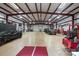 Spacious garage interior with multiple vehicles, overhead lighting, and ample storage at 525 Lake Lynn Rd, Concord, NC 28025