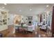 Open-concept living room with fireplace, hardwood floors, and elegant seating, perfect for entertaining at 525 Lake Lynn Rd, Concord, NC 28025