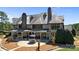 Expansive outdoor patio featuring stone columns, a covered dining area, and serene backyard views at 525 Lake Lynn Rd, Concord, NC 28025