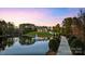 Picturesque view of estate home reflected in serene pond with fountain feature at 525 Lake Lynn Rd, Concord, NC 28025