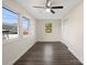 Bright bedroom features a ceiling fan, dark wood floor and large windows at 703 Rankin Ave, Mount Holly, NC 28120