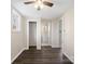 Neutral room with wood-look flooring, features a window, closet, and a view into the updated bathroom at 703 Rankin Ave, Mount Holly, NC 28120
