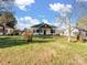 Exterior showcasing the home's facade, yard, and surrounding landscape under a partly cloudy sky at 703 Rankin Ave, Mount Holly, NC 28120