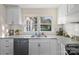 Bright kitchen featuring granite countertops, undermount sink, and stainless steel dishwasher at 703 Rankin Ave, Mount Holly, NC 28120