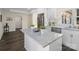 Kitchen island with granite countertops, white cabinets, and stainless appliances for meal prep at 703 Rankin Ave, Mount Holly, NC 28120