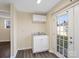 Bright laundry room features wooden floors, white cabinetry, sink, and an exterior door to the backyard at 703 Rankin Ave, Mount Holly, NC 28120