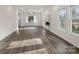 Open living room with new floors, large windows and bright, airy feel at 703 Rankin Ave, Mount Holly, NC 28120