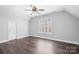 A spacious bedroom featuring hardwood flooring, large window, and ceiling fan with light at 71 40Th Avenue Ne Dr # 7, Hickory, NC 28601