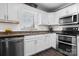 Bright kitchen features white cabinets, stainless steel appliances, and granite countertops at 71 40Th Avenue Ne Dr # 7, Hickory, NC 28601