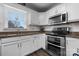Well-lit kitchen featuring white cabinets, granite countertops, and stainless steel appliances at 71 40Th Avenue Ne Dr # 7, Hickory, NC 28601