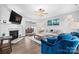Open-concept living room with a fireplace, blue armchair seating, and seamless flow into the dining area at 71 40Th Avenue Ne Dr # 7, Hickory, NC 28601