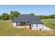 Back exterior of house with wooden deck and stairs at 7419 Tesh Rd, Monroe, NC 28110