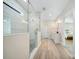 Modern bathroom features a glass shower, wood look tile, and a white vanity at 7419 Tesh Rd, Monroe, NC 28110
