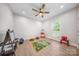 Playroom with ceiling fan, hardwood floor, and filled with variety of toys to keep happy at 7419 Tesh Rd, Monroe, NC 28110