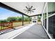 Covered patio with fireplace, ceiling fan, and overlooking a trampoline and the backyard at 7419 Tesh Rd, Monroe, NC 28110
