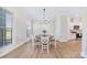 Bright dining room with a round wooden table, white chairs, a chandelier, and natural light at 7419 Tesh Rd, Monroe, NC 28110