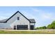 Side-entry garage with black door and adjacent entrance to the home at 7419 Tesh Rd, Monroe, NC 28110