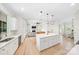 Open-concept kitchen and living room featuring an island, white cabinets, and a cozy seating area with a fireplace at 7419 Tesh Rd, Monroe, NC 28110