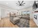 Open-concept living room with a sectional sofa, kitchen, and fireplace at 7419 Tesh Rd, Monroe, NC 28110