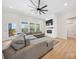 Bright living room with a ceiling fan, fireplace, and hardwood floors at 7419 Tesh Rd, Monroe, NC 28110