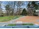 View of the backyard featuring a stone path to an outdoor sitting area with mature trees and landscaping at 801 Glendora Dr, Charlotte, NC 28212
