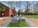 Backyard features a stylish patio with modern outdoor furniture, a grill, and manicured landscaping at 801 Glendora Dr, Charlotte, NC 28212