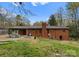 Spacious backyard with a patio and outdoor seating outside of the brick home at 801 Glendora Dr, Charlotte, NC 28212