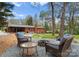 Backyard view featuring a stone fire pit area with outdoor seating and the brick home at 801 Glendora Dr, Charlotte, NC 28212
