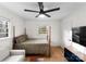 A bedroom featuring a four-poster bed, tv, and sofa at 801 Glendora Dr, Charlotte, NC 28212