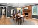 A dining room with a fireplace, wooden table and chairs, and a large mirror at 801 Glendora Dr, Charlotte, NC 28212