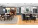 Open-concept kitchen and dining area with modern cabinets, stainless steel appliances, and cozy fireplace at 801 Glendora Dr, Charlotte, NC 28212