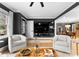 Bright living room features hardwood floors, stylish seating, open access to the dining area, and natural light at 801 Glendora Dr, Charlotte, NC 28212