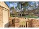 This property features a well-maintained yard with a brick fence and mature trees at 8033 Charter Oak Ln, Charlotte, NC 28226