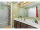 Well-lit bathroom with a tub, shower, vanity, and neutral green color scheme at 8033 Charter Oak Ln, Charlotte, NC 28226