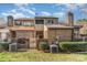 Backyard view of the multi-level brick townhome showing manicured landscaping and a fenced-in yard at 8033 Charter Oak Ln, Charlotte, NC 28226