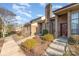 Well-kept brick townhome exterior showing a pathway, neat landscaping, and a welcoming entrance at 8033 Charter Oak Ln, Charlotte, NC 28226