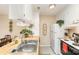 The bright kitchen is equipped with a stainless steel sink, white cabinets, and wooden countertops at 8033 Charter Oak Ln, Charlotte, NC 28226