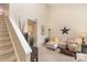 Cozy living room featuring high ceilings, staircase, comfortable seating, and neutral decor at 8033 Charter Oak Ln, Charlotte, NC 28226