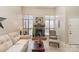 Inviting living area featuring a brick fireplace, neutral decor, and plenty of natural light at 8033 Charter Oak Ln, Charlotte, NC 28226
